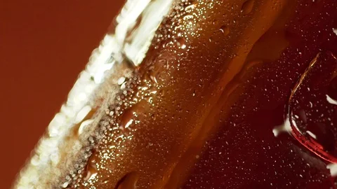 Water drops on the cooled bottle of brandy or whiskey on brown background. Macro Stock Footage 96239052
