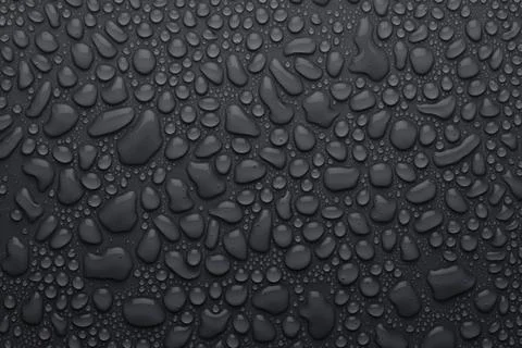 Water drops on dark grey background as elegant pattern with formless and roun Stock Photos