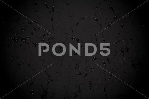 Water drops on dark stone surface Stock Photos