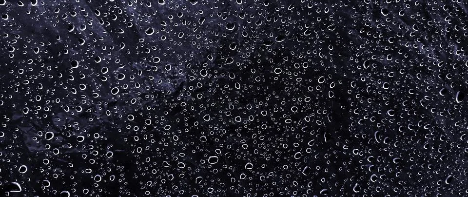 Water drops on dark surface background texture with condensation and rain d.. Stock Photos