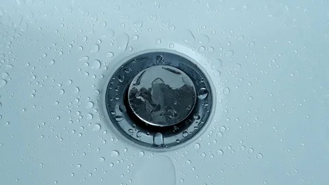 Water drops drip falling into the water of white, clean sink - 2 Stock Footage 101235710