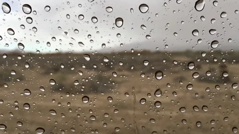 Water drops dripping on the car window Stock Footage 336437834