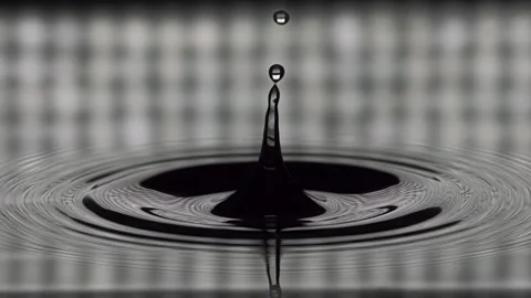 Water drops dripping onto the water surface Stock Footage 150722659