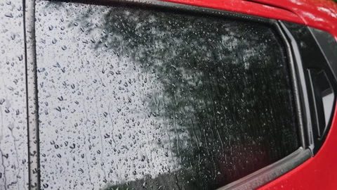 	Water drops during rain roll down the side window of a car. Stock Footage 313371462