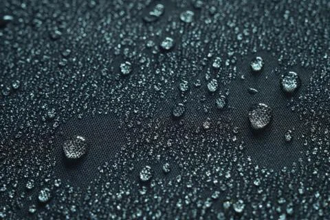 Water drops on the fabric surface macro photo Stock Photos