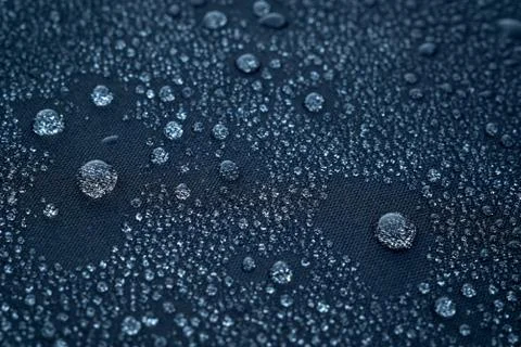 Water drops on the fabric surface macro photo Stock Photos