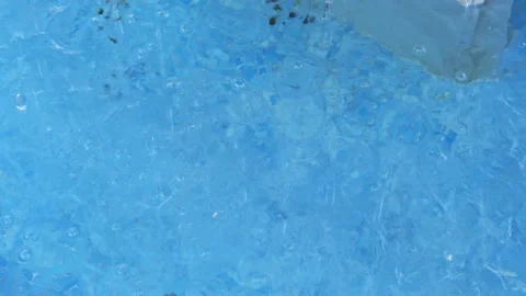 Water drops fall into the blue pool Stock Footage 169370845