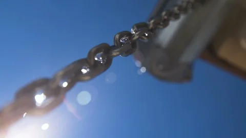 Water drops falling and running down the rain chain Stock Footage 99740803