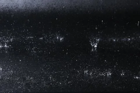 Water drops falling on black background. Rainy weather Stock Photos