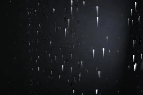 Water drops falling on black background. Rainy weather Stock Photos