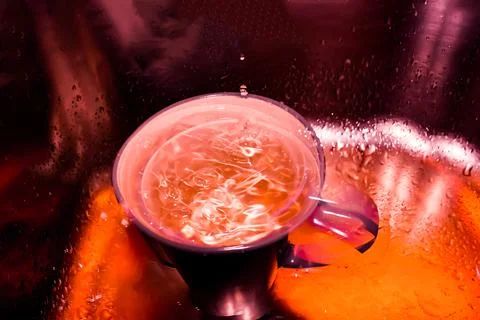 Water drops falling into the cup Stock Photos