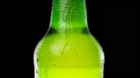 Water drops falling down on the glass of beer.  Stock Footage 153275113