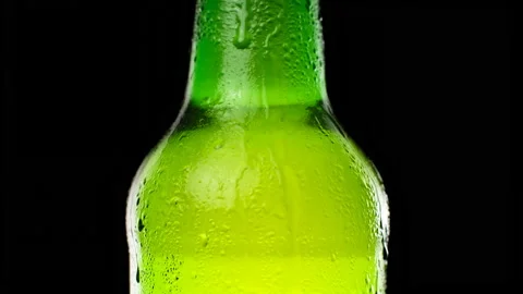 Water drops falling down on the glass of beer. Water drops on green glass Stock Footage 155436460