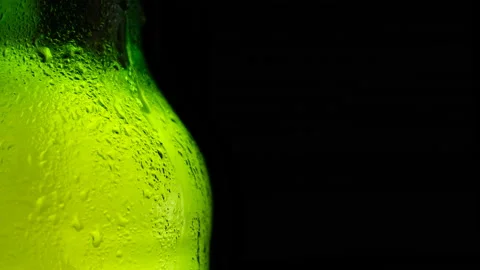 Water drops falling down on the glass of beer. Water drops Stock Footage 155436624