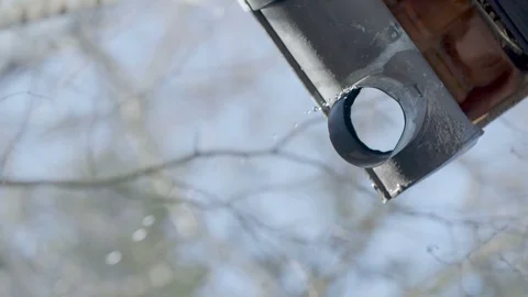 Water drops falling down from a metal roof gutter Vídeo Stock 99742412