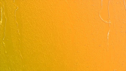 Water drops falling down orange glass 4K Stock Footage 253267941
