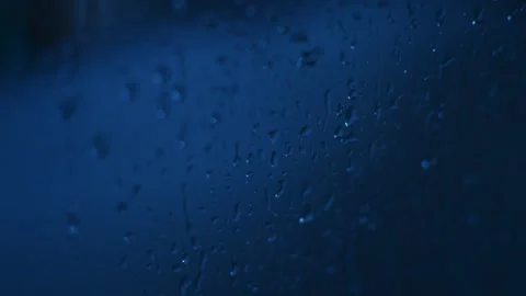 Water drops falling on a glass window. water drops motion texture background. Video stock 209189835