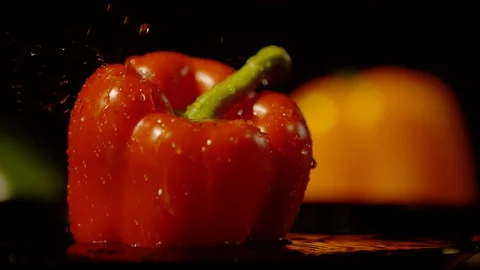 Water drops falling on a red bell pepper, Ultra Slow Motion Stock Footage 86585585
