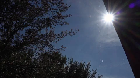 Water drops falling from the side of a rooftop during the sunshine Stock Footage 336441988