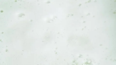 Water drops falling in white foam, top view. Soap foam texture surface back.. Stock Footage 271232104