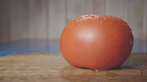Water drops falls on tomato Stock Footage 73816257