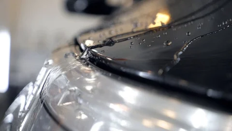 Water drops flow on a black car after car wash slow motion. Stock Footage 86437010