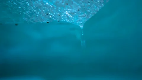 Water drops flowing down from blue ice Stock Footage 148053820