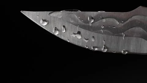 Water drops on forged sharp handmade knife isolated on black background Stock Footage 303275767