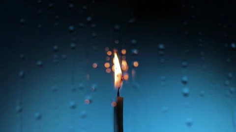 Water drops in front of candle Stock Footage 130180871