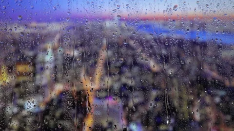 Water drops on a glass surface. Window with cityscape background. Rain drops. Stock Footage 235367144
