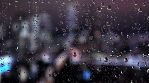 Water drops on a glass surface. Window with cityscape background. Rain drops. Stock Footage 235367190
