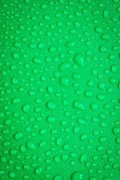 Water Drops On Green Background. Stock Photos
