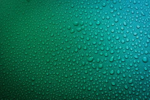 Water Drops On Green Background. Stock Photos