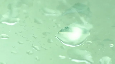 Water drops on green surface Stock Footage 98545628