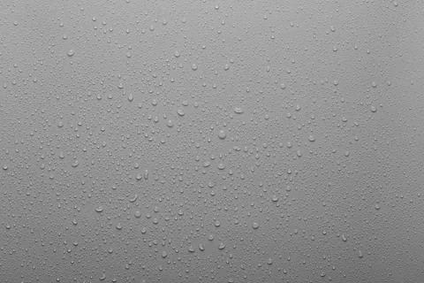 Water drops on a grey plastic surface Stock Photos