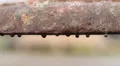 Water drops hanging on decaying rusty metal surface of old utility system HD Footage