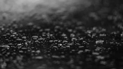 Water drops lying on a shiny surface. Moody photo. Depth of field Stock Photos
