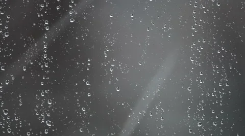 Water drops from melted snow on window glass against grey background Stock Footage 56206084