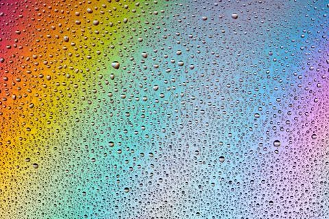 Water Drops on multi-colored rainbow Background. 스톡 일러스트