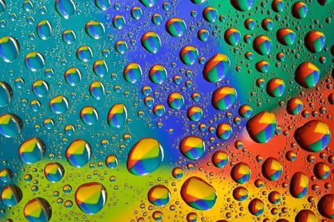 Water drops on multicolor background Stock Photos