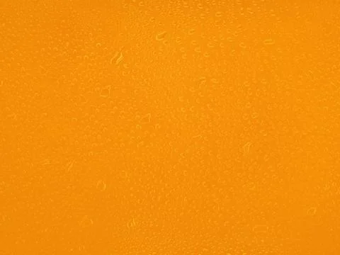 Water drops on orange background texture. backdrop glass covered with drops o Stock Photos