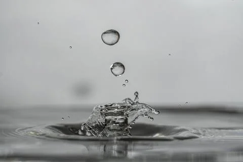 Water drops over an explosive crown sculpture, created from water drop collision Stock Photos