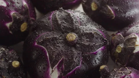 WATER DROPS OVER ROUND  EGGPLANTS Stock Footage 132535414