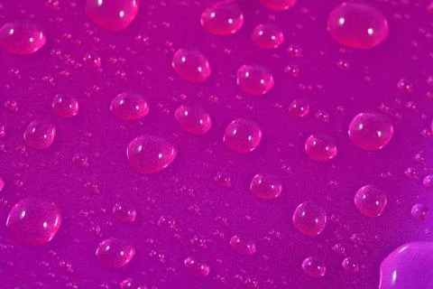 Water drops on pink background. Selective focus. Stock Photos