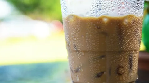 Water drops on the plastic glass of iced coffee Stock Footage 64313448