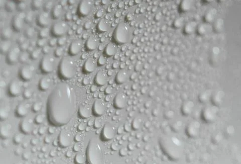 Water drops on a plastic surface, macro photography. Stock Photos