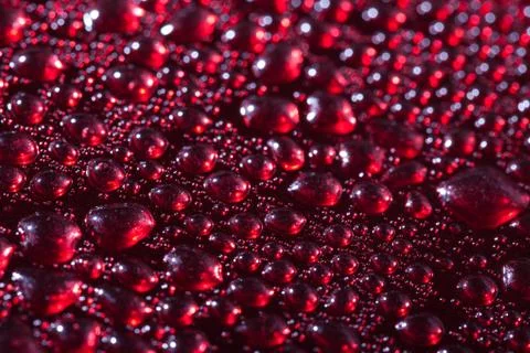 Water drops on the red background Stock Photos