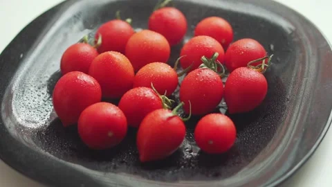 Water drops on red cherry tomatoes Stock Footage 133344687