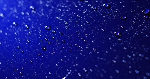 Water drops roll off the car surface. Reflecting waterdrops on blue surface Stock Footage 111255588