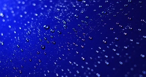 Water drops roll off the car surface. Reflecting waterdrops on blue surface Stock Footage 111256620
